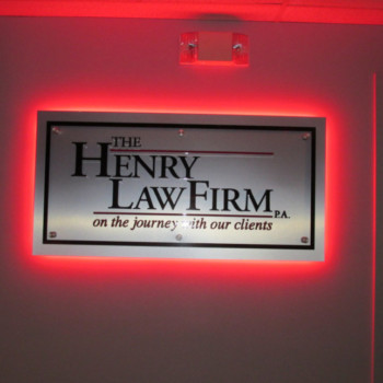 Cut Acrylic Letters adhered to Clear Acylic Panel, mounted with Standoffs to Brushed Aluminum Panel, with red halo lit LEDs